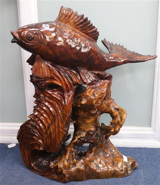 A large Oriental carved rootwood model of a leaping carp